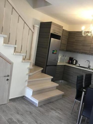 a staircase in a room with a kitchen and a kitchenasteryasteryasteryasteryastery at Anna House in Nikiti