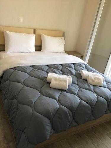 a large bed with two pillows on top of it at Anna House in Nikiti