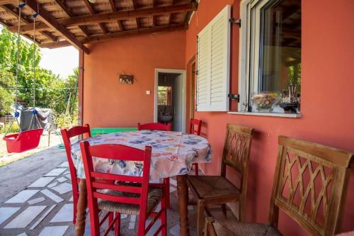 a table and chairs on the porch of a house at Summer front sea house for a relaxing get-away! in Pýrgos