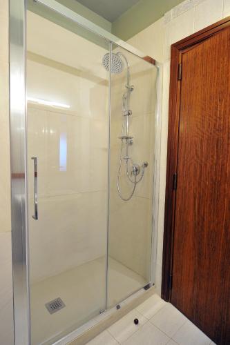 a shower with a glass door in a bathroom at Grand Hotel Cesare Augusto in Sorrento