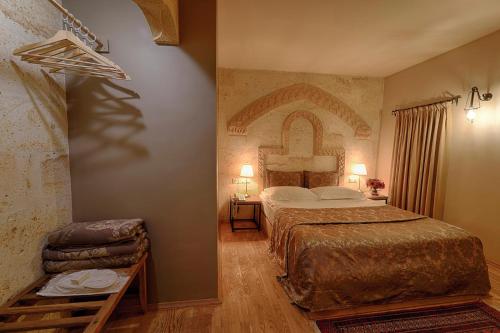 a hotel room with a bed and a bedroom with at Heybe Hotel & Spa in Goreme