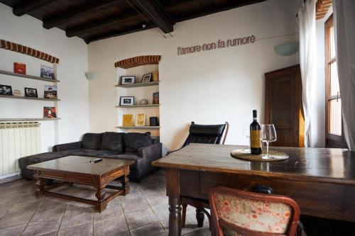 a living room with a table and a couch at Borgo Dora House in Turin