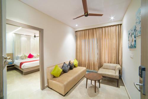 a living room with a couch and a bed at The Beacon Hotel Visakhapatnam in Visakhapatnam