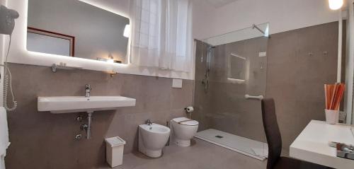a bathroom with a sink and a toilet and a mirror at Belvedere del Lago in Montefiascone