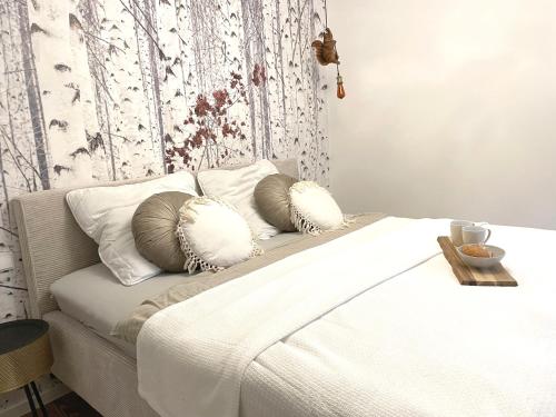 a white bed with two pillows on top of it at Fuchs-Fichte in Bad Harzburg