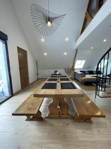 a large room with a large wooden table in it at Chaleur Moderne des Pyrénées in Argelès-Gazost
