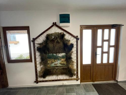 a mirror on a wall next to a door at Pensiunea Vis Alpin Belis in Beliş
