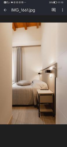 a bedroom with a bed and a table in a room at Locanda del vecchio mulino in Fiorano Modenese