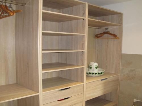 a wooden bookcase with wooden shelves in a room at Holiday Home Miche by Interhome in Collabassa