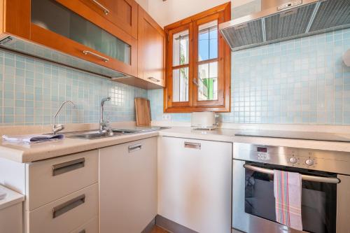 a kitchen with a sink and a stove at Moli 37 House - Port View Terrace in Palma de Mallorca