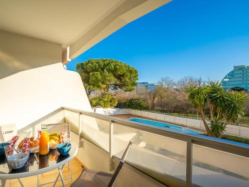 a balcony with a table with fruit on it at Studio du Parc I by Interhome in La Grande Motte