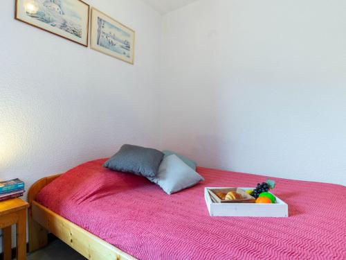 a bed with a bowl of food on top of it at Apartment Les Mousquetons-19 by Interhome in La Toussuire