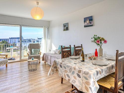 a living room with a dining room table and a bed at Apartment Kérabus-1 by Interhome in Quiberon