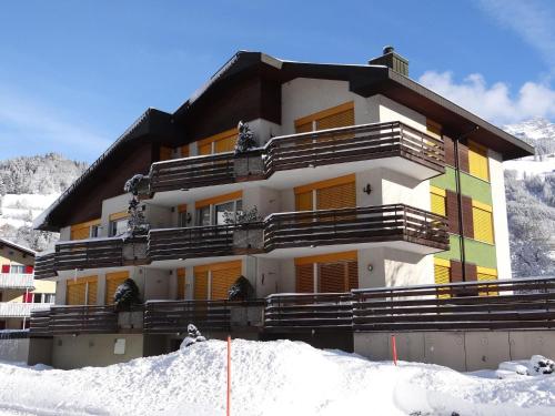 a building on top of a snow covered mountain at Apartment Birkenstrasse 52 Wohnung 2 by Interhome in Engelberg