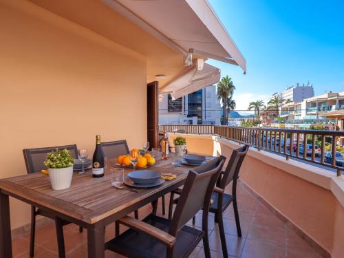 a wooden table on the balcony of a house at Apartment Nice 4 You by Interhome in Port d'Alcudia
