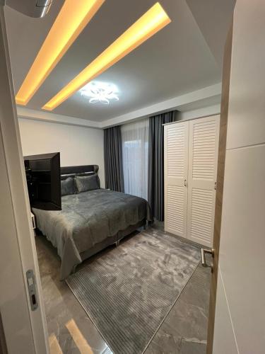 a bedroom with a bed and a television on a ceiling at PERLI TOWERS in Alanya