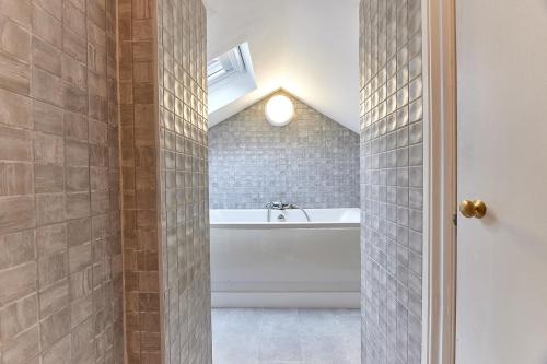 a bathroom with a bath tub and a sink at Dene Annexe, Durham in Shincliffe