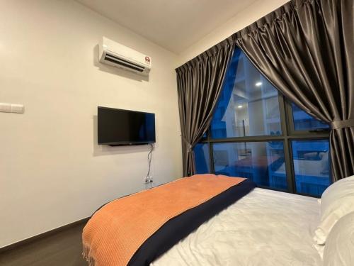 a bedroom with a bed and a window and a television at SKS Pavillion Minimalistic and Cozy studio in Johor Bahru
