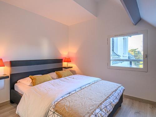 Un dormitorio con una cama grande y una ventana. en Apartment Les Galiotes-3 by Interhome, en Carnac
