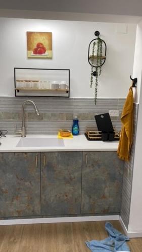 a kitchen with a sink and a counter top at בין יער לים in Shlomi