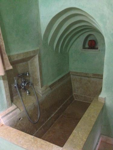 a bathroom with a shower with a shower head at Kasbah Titrit & Spa in Aït Ben Haddou