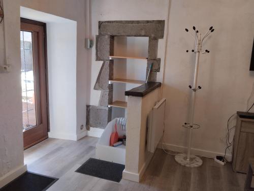 a room with a fireplace in the corner of a room at Appartement Le Paradou à Besse in Besse-et-Saint-Anastaise