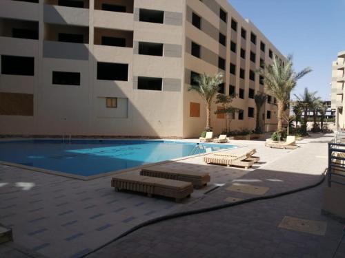 a swimming pool in front of a building at Princess resort unit number 260A Markos in Hurghada