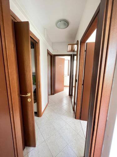 a hallway with doors and a tile floor at Gramsci suite home in Casa la Luna