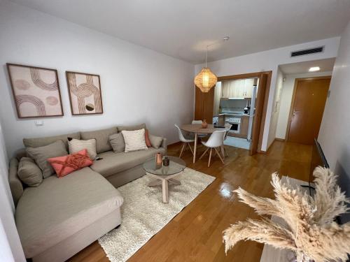 a living room with a couch and a table at Apartamento Playa Delicias in Águilas