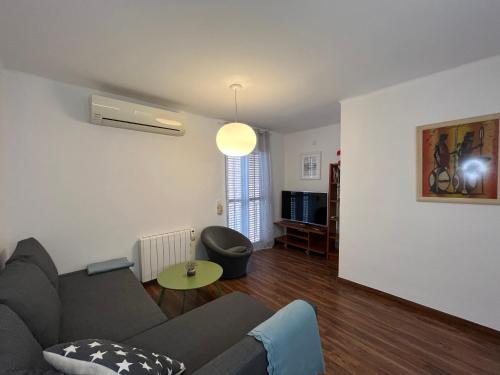 a living room with a couch and a table at August centro Tarragona in Tarragona