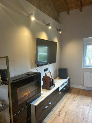 a living room with a fireplace and a flat screen tv at Lekuona in Galdakao