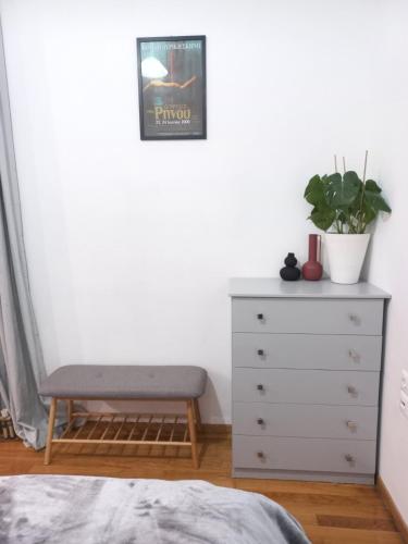 a bedroom with a bed and a dresser and a plant at The Valkyries 2 in Leonidion