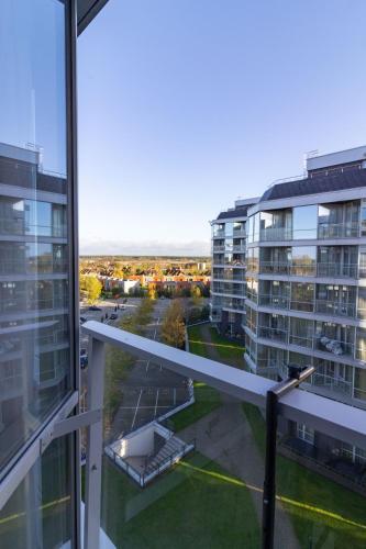 a view from the balcony of a building at Elija Swan-Toy Apartments in Šventoji