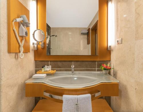 a bathroom with a sink and a mirror at Point Hotel Taksim in Istanbul