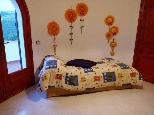 a bedroom with a bed with a comforter on it at Chalet en Alcossebre in Alcossebre