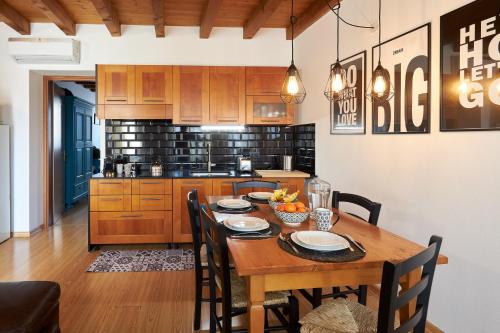 a kitchen with a wooden table and a dining room at Residence "Professor's nest" - Verona Apartments in Verona