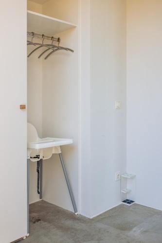 a bathroom with a white sink and a mirror at Landgoed Moerslag in Sint Geertruid
