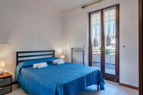 una camera da letto con un letto blu e asciugamani di Terrazza di Leonardo - 2 bedrooms apartment a San Martino della Battaglia