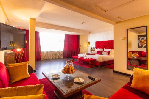 Le Zenith Hotel & Spa في الدار البيضاء: غرفة معيشة مع أريكة وسرير وطاولة