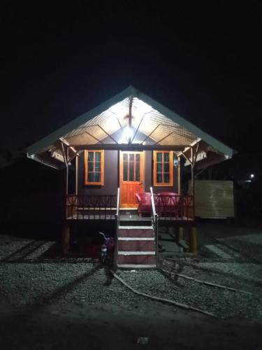 ein Haus mit einem beleuchteten Dach in der Nacht in der Unterkunft Pondok orange FIFA almahera in Binjai