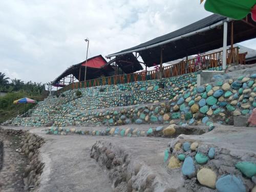 a stadium filled with lots of rocks and a building at Pondok orange FIFA almahera in Binjai
