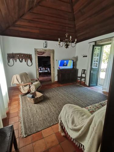 a living room with a bed and a mirror at Casa das Torres da Facha in Ponte de Lima