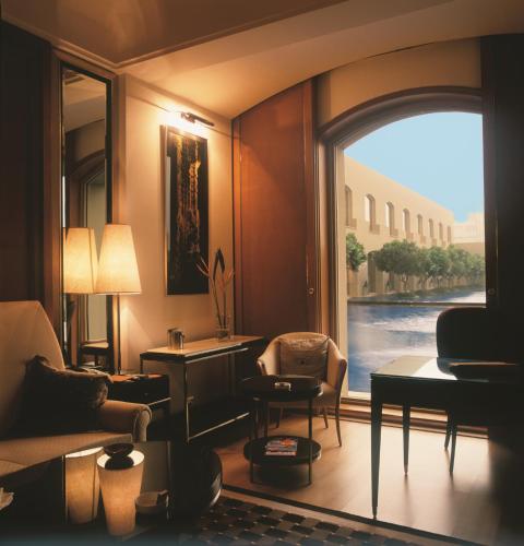 a living room with a large window with a view at Trident Gurgaon in Gurgaon