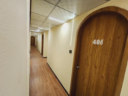 a hallway with a wooden door with the number at Hotel Nova Bopal in Bodakdev