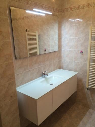 a bathroom with a white sink and a mirror at Casa Serenella - Bilocale a due passi dal mare in Sanremo