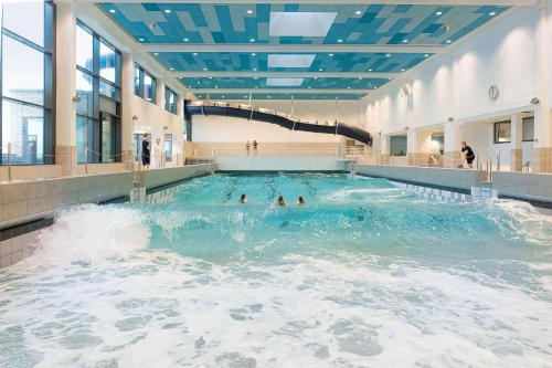 a swimming pool with people in the water at Boutique-Hotel Zur alten Post in Büsum