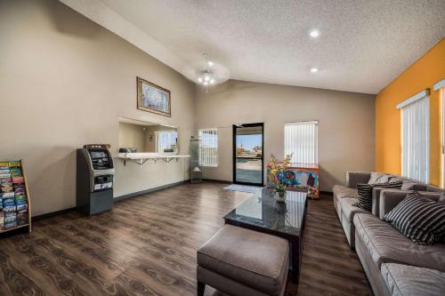 a living room with a couch and a table at Econo Lodge San Antonio near SeaWorld - Medical Center in San Antonio