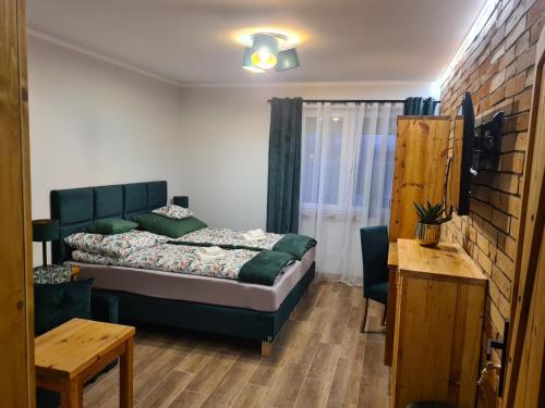 1 dormitorio con 1 cama en una habitación con mesa en Solanki Loft Kładka, en Inowrocław