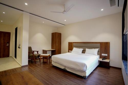 a bedroom with a large white bed in a room at The Amber hotel in Ambikāpur