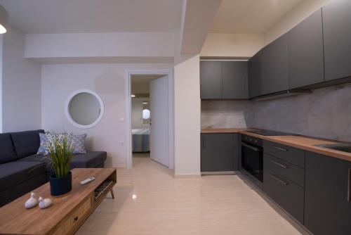 a kitchen and living room with a couch and a table at Creta Vivere Villas in Agia Pelagia